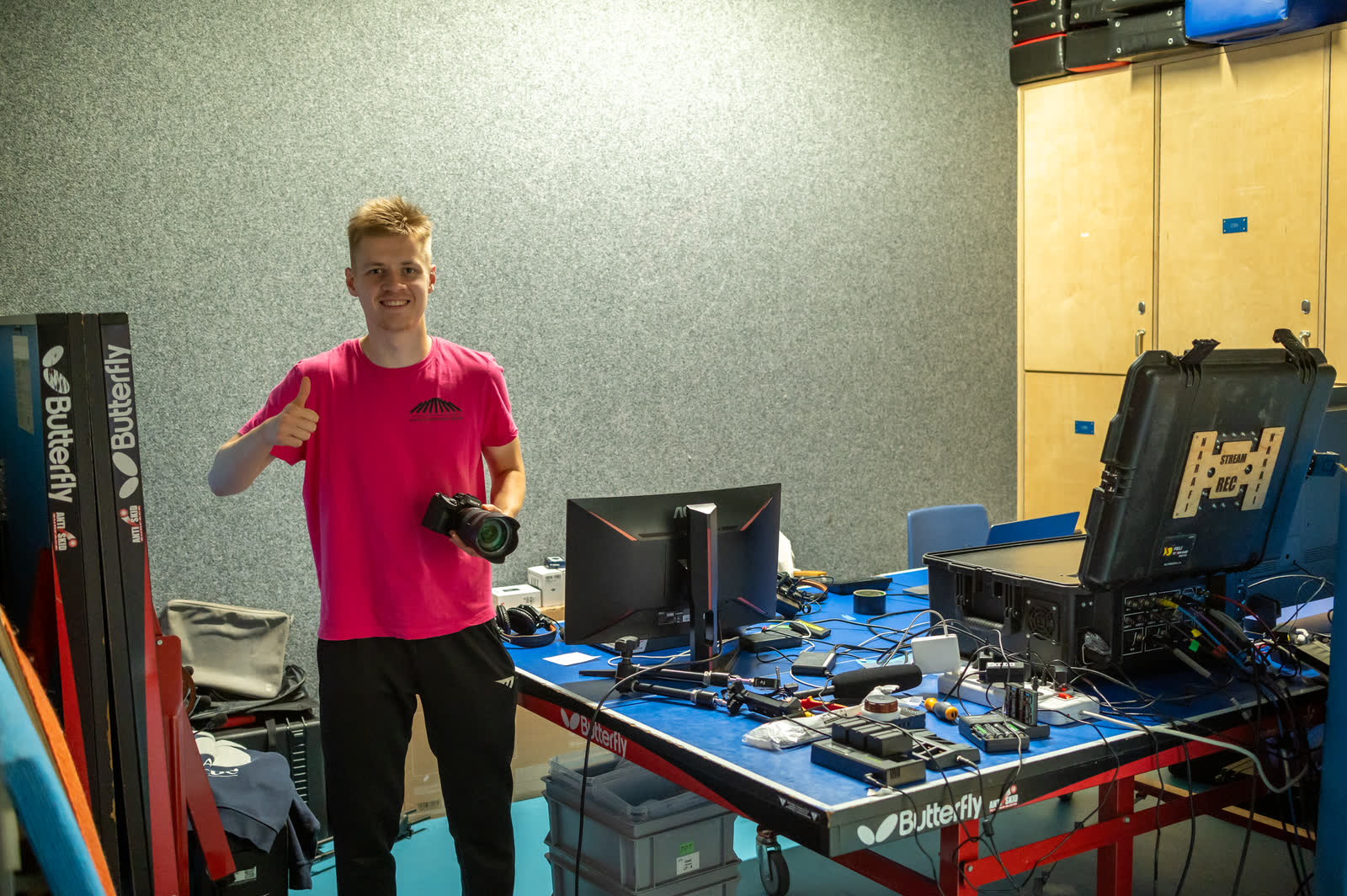 Ivan on set with his camera, giving a thumbs up