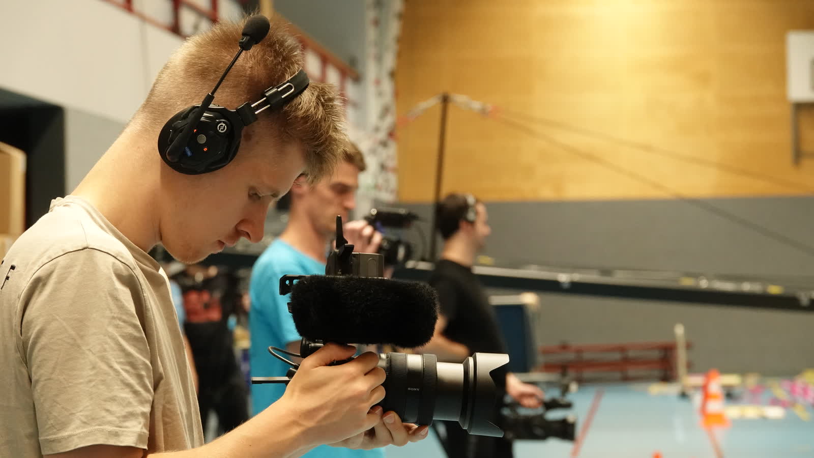 Ivan filming with headset and shotgun mic